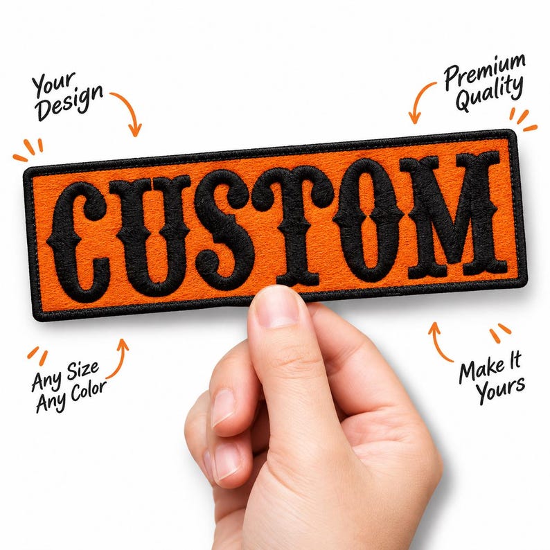 May include: A rectangular embroidered patch with an orange background and a black border. The word CUSTOM is stitched in large black serif letters across the center. Surrounding text includes Your Design, Premium Quality, Any Size Any Color, and Make It Yours.