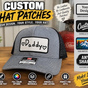 Könnte beinhalten: Eine graue und schwarze Trucker-Cap mit einem rechteckigen weißen Aufnäher, der den Text Daddy und Herzsymbole zeigt. Das Bild enthält Textüberlagerungen, die für individuelle Hutaufnäher und verschiedene Designoptionen werben.