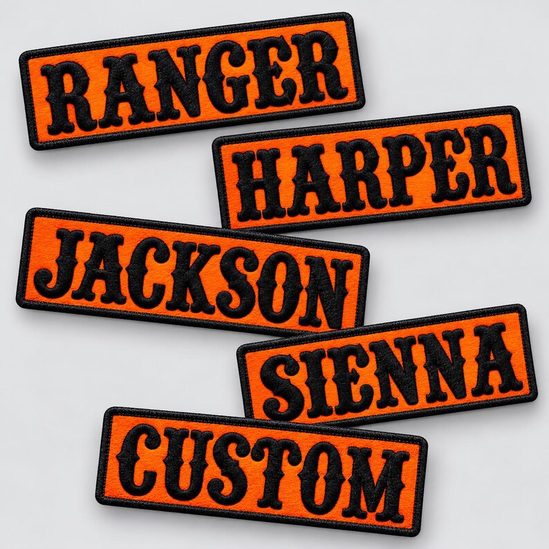 May include: Five rectangular embroidered patches with bright orange backgrounds and black borders. Each patch features black text in a bold, serif font. The names displayed are RANGER, HARPER, JACKSON, SIENNA, and the word CUSTOM.