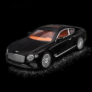 May include: A black luxury coupe with silver trim and wheels. The car has an orange interior and a sunroof. The front features a chrome grille and headlights. The car is set against a black background.