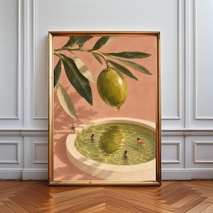 May include: A framed wall art print featuring a large green olive hanging from a branch above a circular swimming pool. Several small figures are swimming in the water, which reflects the olive. The background is a solid muted peach colour.