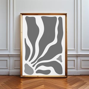 May include: A rectangular wall art print in a gold frame featuring a white background with abstract, organic grey shapes that flow upward from the bottom left corner, creating a series of curved, fluid forms across the vertical composition.