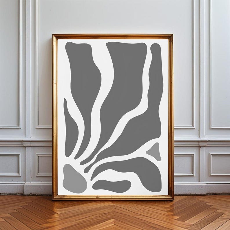 May include: A rectangular wall art print in a gold frame featuring a white background with abstract, organic grey shapes that flow upward from the bottom left corner, creating a series of curved, fluid forms across the vertical composition.