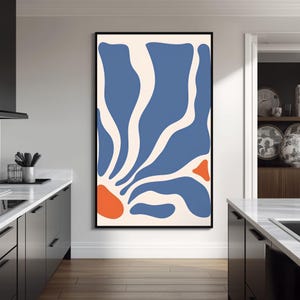 May include: A vertical rectangular wall art piece in a black frame featuring an abstract design with organic, flowing blue shapes on a cream background, accented by two distinct orange rounded forms at the bottom left and middle right edges.