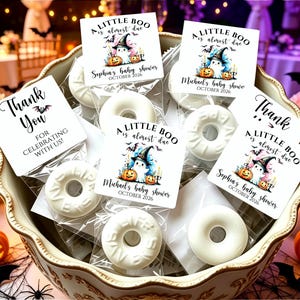May include: White ring-shaped soaps in clear plastic bags with square tags featuring a ghost in a witch hat, pumpkins, and the text A LITTLE BOO is almost due, Sophia's baby shower, Michael's baby shower, and THANK YOU FOR CELEBRATING WITH US.