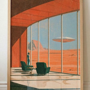 May include: A framed art print depicting a futuristic interior with floor-to-ceiling windows overlooking a vast orange desert landscape. Two dark green armchairs sit on a polished floor, while a silver flying saucer hovers in the distant sky.