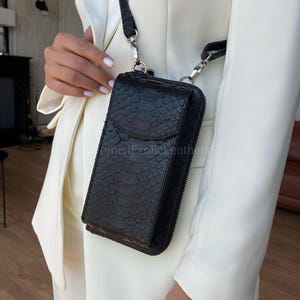 May include: A distressed wooden sign with the words "Welcome to our home" in white. The sign has a rustic finish and a simple design, ideal for a front door.