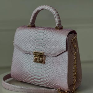 May include: A set of three ceramic mugs with a speckled, matte finish in cream, light brown, and dark brown. Each mug has a simple design and a rounded handle.