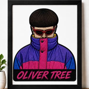 May include: A framed embroidered patch featuring a portrait of Oliver Tree with a bowl cut, red sunglasses, and a high-collared purple and pink jacket. The name OLIVER TREE is embroidered in pink text on a black rectangular background at the bottom.