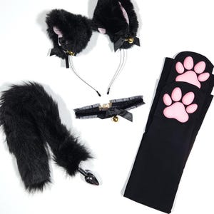 May include: A Catboy Starter Pack with black faux fur cat ears, a matching tail, a choker, and black leg warmers with pink paw prints. The ears and choker have small bells. The text "CATBOY STARTER PACK" is at the bottom.