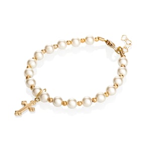 May include: A gold bracelet with white pearls and a small gold cross charm.