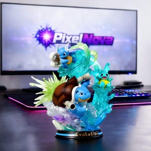 Puede incluir: Una detallada figura con múltiples personajes de dibujos animados azules y marrones que emergen de un efecto de agua azul translúcido. La base de la figura dice "Evolution". El fondo incluye un monitor de ordenador con el texto "Pixel Nova".