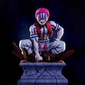 May include: A detailed figurine of a character with pink hair and blue markings. The figure is in a crouching pose, wearing white pants, and a red scarf. The base is a stone-like structure with wooden accents.