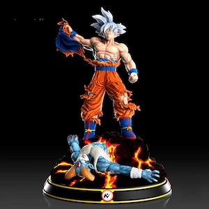 May include: A detailed figurine of a muscular character with spiky white hair, wearing torn orange pants and a blue sash. The figure stands over a defeated blue-skinned opponent on a fiery base. The base is black with a gold trim.