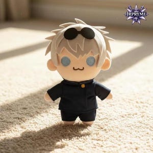 May include: A plush doll of a character with spiky, light-colored hair and black sunglasses. The doll has a black uniform with a gold button and light blue eyes. The doll is standing on a beige carpet.