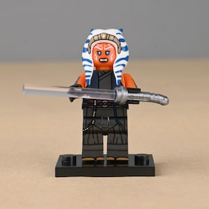 May include: A set of three ceramic mugs with a speckled, matte finish. The mugs are in shades of cream, light gray, and dark gray. Each mug has a simple, minimalist design, perfect for coffee or tea.