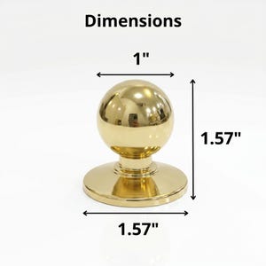 May include: A gold-coloured cabinet knob with a spherical top and a circular base. The knob is 2.54 cm wide and 4 cm tall. The word "Dimensions" is above the knob.