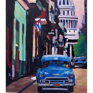 May include: A painting of a blue vintage car driving down a street in Havana, Cuba. The car is driving past a building with a green facade and a Cuban flag hanging from a window. In the background, a white building with a dome can be seen.