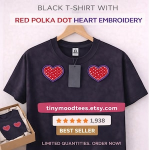 May include: A black t-shirt with red polka dot heart embroidery. The shirt has two heart-shaped patches with red polka dots and a purple border. The text "tinymoodtees.etsy.com" is visible. It is a best seller.