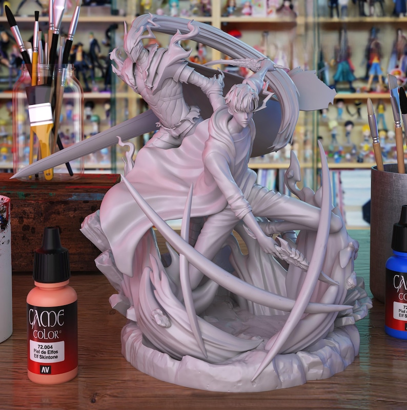 May include: An unpainted resin figurine showing two figures in a battle scene. One figure is armored and wielding a sword. Paint bottles and brushes are visible in the background. The figurine is ready for painting.