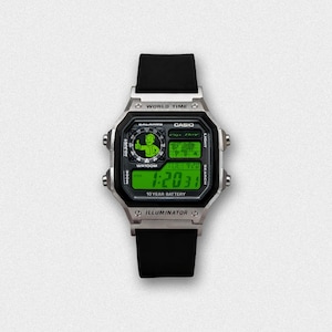 May include: A silver Casio digital watch with a black band and green digital display. The watch face features the text "WORLD TIME", "CASIO", and "ILLUMINATOR". The display shows the time as 1:20:31 and the date as TUE 4/20.