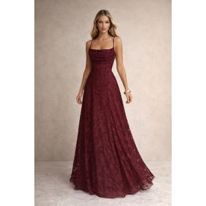 May include: A white ceramic mug with a black handle and the text "But First, Coffee" in a bold, black font. The mug is set against a blurred background, suggesting a cozy setting. The mug appears to be approximately 4 inches tall.