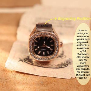 May include: A rose gold ring watch with a square black face and a crystal-studded bezel. The watch has the word "QUARTZ" on the face. The text "Sophia" is above the watch face. The image also includes text about engraving.