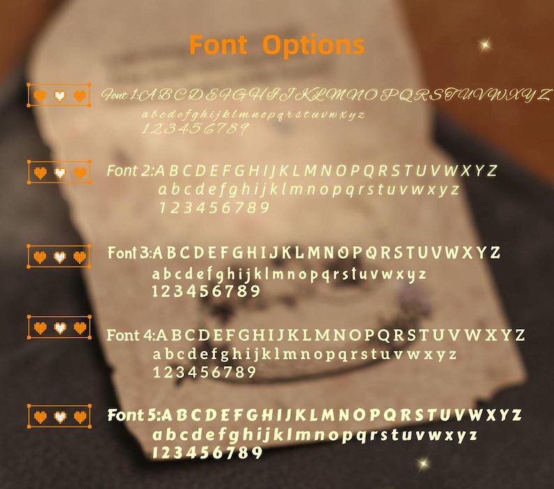 Puede incluir: Primer plano de un papel con opciones de fuente. El texto "Font Options" es de color naranja. Se muestran cinco estilos de fuente, cada uno con alfabetos en may&uacute;sculas y min&uacute;sculas y n&uacute;meros. Cada fuente est&aacute; etiquetada con un n&uacute;mero y un icono de coraz&oacute;n.