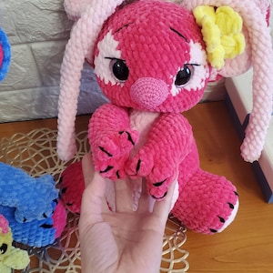 May include: A set of three ceramic canisters with lids. The canisters are white with a blue floral pattern. The largest canister is 8 inches tall, the medium is 6 inches, and the smallest is 4 inches.