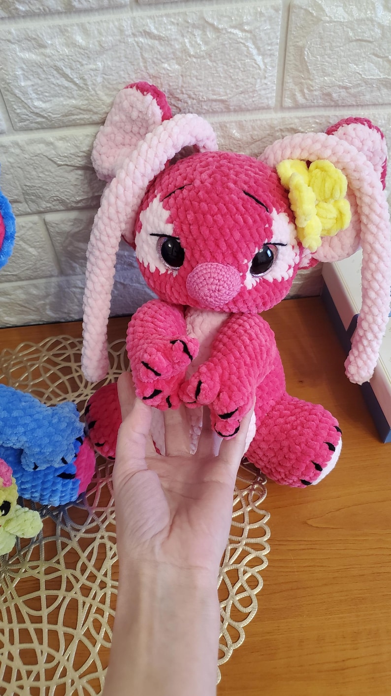 May include: A set of three ceramic canisters with lids. The canisters are white with a blue floral pattern. The largest canister is 8 inches tall, the medium is 6 inches, and the smallest is 4 inches.
