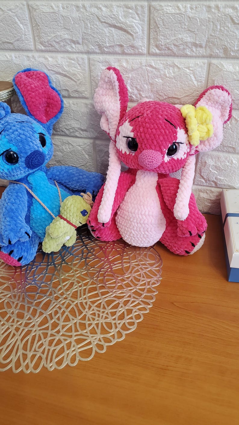 May include: A white ceramic mug with a black handle and the text "But First, Coffee" in a bold, black font. The mug is set against a blurred background, suggesting a cozy setting.