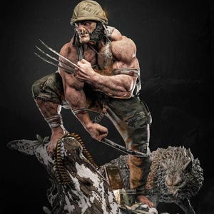 May include: A detailed statue of Wolverine in a combat helmet with the text "TO KILL" on it. The figure is muscular, holding metal claws, and stands on a snowy base with a wolf. The statue is in a dynamic pose.