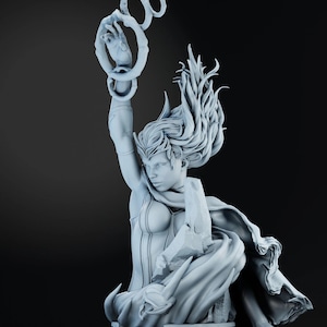 May include: A light gray statue of a woman with long flowing hair, wearing a cape and holding a ring of circles. The statue is detailed with intricate designs and is set against a dark background.