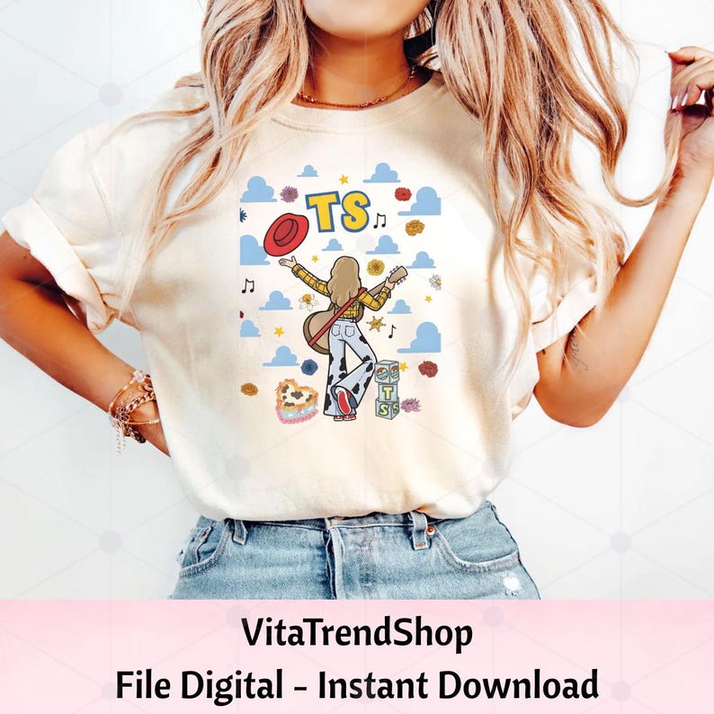 May include: A cream-colored t-shirt featuring a graphic print of a person with long hair holding a guitar, wearing a yellow plaid shirt and cow-print pants. The design includes a red hat, blue clouds, musical notes, flowers, and blocks with the text TS.