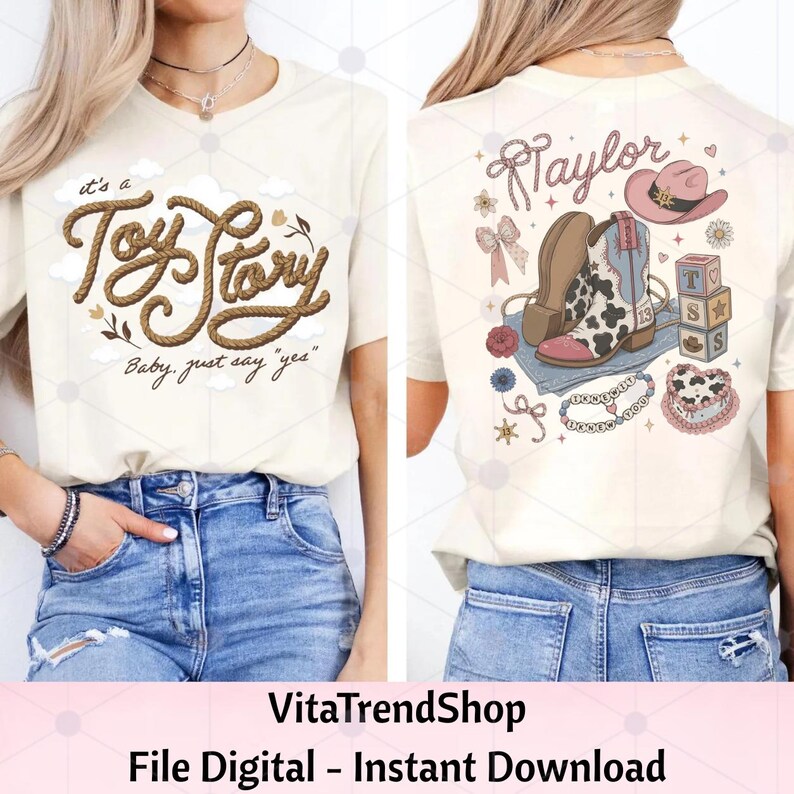 May include: A cream-colored t-shirt featuring a front graphic with the text "it's a Toy Story Baby, just say yes" in rope-style lettering. The back graphic displays the name "Taylor" with cowboy boots, a hat, blocks, and a heart-shaped cake.