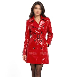 May include: A bright red trench coat made of a glossy, patent-like material. This double-breasted coat features a wide collar, shoulder epaulets, long sleeves with buckled cuffs, and a matching waist belt with a black buckle. The coat has two side pockets.