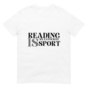 May include: White t-shirt featuring the text "READING IS MY FAVOURITE SPORT" in black and grey lettering. The shirt has a crew neck and short sleeves.