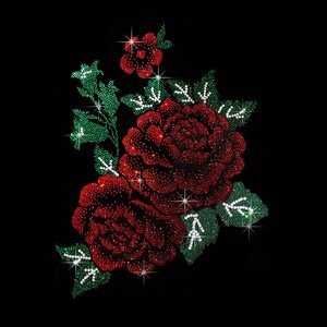 May include: A floral applique design composed of numerous small red and green rhinestones. The pattern features two large blooming roses, a smaller flower at the top, and several green leaves with white rhinestone veins on a black background.