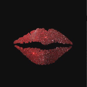 May include: A graphic design of a pair of lips rendered in vibrant red, sparkling rhinestones set against a solid black background. The lips are depicted in a slightly parted position, with the individual crystals creating a textured, reflective surface.