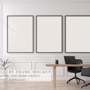 May include: Three vertical rectangular frames with dark brown borders mounted on a white wall above a wooden desk. The desk features a black laptop, a black office chair, and a small potted plant. Text reads GALLERY FRAME MOCKUP 3 FRAMES.