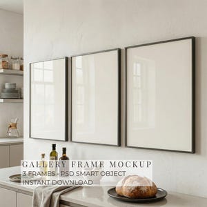 May include: Three black framed gallery frames hanging on a white wall. The frames are empty, with a white interior. The image also shows a kitchen counter with bottles, a bowl, and a loaf of bread. Text on the image reads: GALLERY FRAME MOCKUP, 3 FRAMES, PSD SMART OBJECT, INSTANT DOWNLOAD.