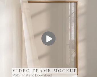 May include: A rectangular video frame mockup with a light wood border. The frame is set against a neutral-toned wall with a sheer white curtain on the left. The text "VIDEO FRAME MOCKUP PSD • Instant Download" is at the bottom.