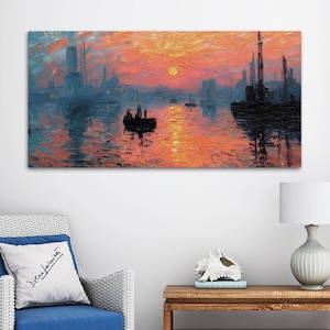 May include: A rectangular canvas print of an impressionistic seascape. The artwork depicts a sunset over a body of water, with boats and buildings silhouetted against the orange and blue sky. The sun is a bright yellow circle.