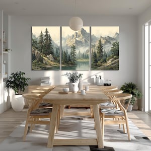 May include: A triptych canvas art piece depicting a serene mountain landscape with a lake and evergreen trees. The artwork features soft colors and a misty atmosphere, creating a calming ambiance. The art is displayed above a wooden dining table.