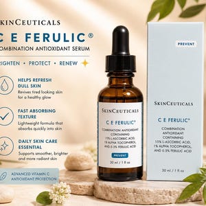 May include: An advertisement for a skincare product, showing a brown glass bottle with a dropper and a light blue box. The bottle and box display the product name "CE Ferulic" and information about its antioxidant properties. The bottle contains 30 ml / 1 fl oz.