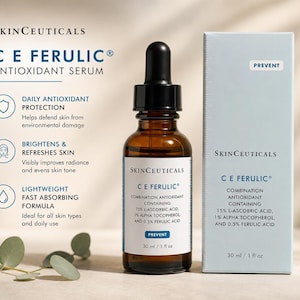 May include: A brown glass bottle of SkinCeuticals C E Ferulic antioxidant serum with a black dropper, next to a light blue box. The bottle and box both have white text, including the words "Prevent" and "30 ml / 1 fl oz."
