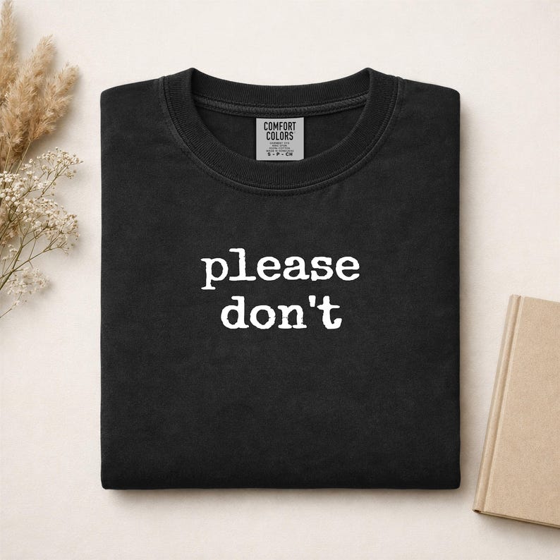 Black Comfort Colors t-shirt with "please don't" printed in white text.