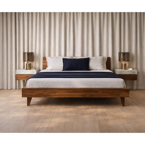 May include: A modern bedroom setup featuring a wooden bed frame with a dark blue throw blanket and white bedding. Two floating nightstands with lamps flank the bed. The background includes neutral-colored curtains and a wooden floor.