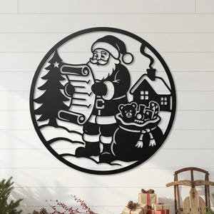 May include: A circular black metal wall art piece featuring a cutout silhouette of Santa Claus holding a scroll, standing next to a Christmas tree, a small house, and a sack filled with toys, all enclosed within a thin circular frame.
