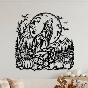 May include: A black metal wall art piece featuring a silhouette of a wolf howling at a full moon. The design includes a bare tree, flying bats, mountain peaks, a wooden fence, and several pumpkins with maple leaves at the base of the scene.